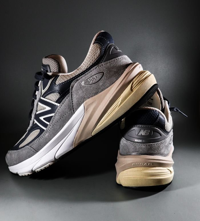 Home Modern gray and black sneakers displayed on a dark background, perfect for fashion enthusiasts.